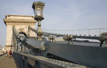 Hungary, Pest County, Budapest, tourists crossing Szechenyi Chain Bridge or Memory Bridge on foot and bicycle.