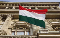 Hungary, Pest County, Budapest, Hungarian flag flying from building facade.