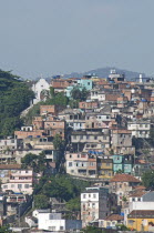 BRAZIL Rio de Janeiro Favela or slum above Saude neighbourhood - some traditional tile roofs very steep hill roads greenery and Church