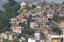 BRAZIL Rio de Janeiro Favela or slum above Saude neighbourhood some traditional tile roofs very steep hill roads greenery and Church.
