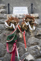 Hungary, Pest County, Budapest, memorial to Holocaust victim Miklos Radnoti, birth name Miklos Glatter, 5 May 1909 to 10 November 1944, a Hungarian poet. With dried and freshly placed wreaths hung wit...