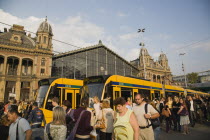 Hungary, Pest County, Budapest, trams and crowd of passengers in front of rail terminus Budapest Nyugati palyaudvar.