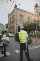 Hungary, Pest County, Budapest, Hungarian traffic police wearing high visability jackets on road outside The Great Synagogue, also known as Dohany Street Synagogue.