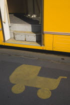 Hungary, Pest County, Budapest, painted marking on pavement at tram stop depicting pram with open door of  tram stopped beside it.