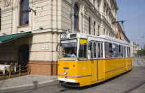 Hungary, Pest County, Budapest, tram with female driver in street on bank of the River Danube, Buda at approach to Chain Bridge.