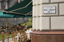 Hungary,  Pest County, Budapest, Buda cafe beside the River Danube at approach to Chain Bridge with people seated at outside tables.