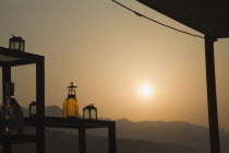 Greece, Northern Aegean, Samos, Vathy, Sun setting behind open air bar with the Ampelos massif beyond.