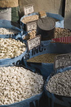 Greece, Attica, Athens, Sacks of beans for sale displayed on food stall.
