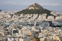 Greece, Attica, Athens, Mount Lycabettus rising in central Athens with densely populated city below.