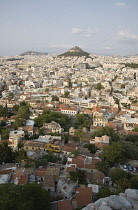 Greece, Attica, Athens, Mount Lycabettus rising in central Athens with densely populated city below.