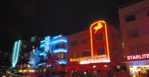 USA, Florida, Miami, South Beach, Ocean Drive, Art Deco buildings illuminated at night, Colony and Boulevard Hotels with colourful neon signs.