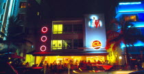 USA, Florida, Miami, South Beach, Ocean Drive, Exterio of Johnny Rocket's diner illuminated at night with neon lights.