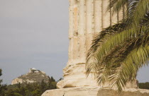 Greece, Athens, The Temple of Olympian Zeus, column base of ruined temple dedicated to king of the Olympian gods, Zeus with Mount Lycabettus rising behind.