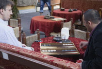 Turkey, Istanbul, Sultanahmet, Men at an outdoor cafe playing Tavla, a very popular tables game in Turkey similar to backgammon. The major difference is in tavla the doubling cube is not used, also in...