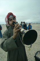 Bahrain, Traditional musician playing horn instrument.