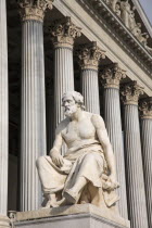 Austria, Vienna, Statue of the Greek philosopher Thucydides in front of the columns to the Parliament Building.