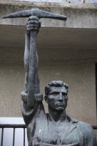 Albania, Tirana, Statue of communist worker holding pickaxe.