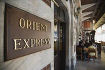 Turkey, Istanbul, Sultanahmet, Orient Express sign beside cafe on station platform. Istanbul Sirkeci Terminal or Sirkeci is a terminus main station of the Turkish State Railways or TCDD in Sirkeci, on...
