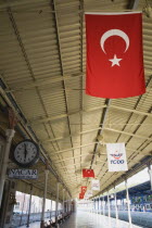 Turkey, Istanbul, Sultanahmet, View along railway platform with Turkish flags hanging from the roof. Istanbul Sirkeci Terminal or Sirkeci GarA is a terminus main station of the Turkish State Railways...