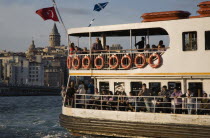 Turkey, Istanbul, Sultanahmet, Crowded passenger ferry flying Turkish flag on the Bosphorous with city behind. Since March 2006, Istanbuls traditional commuter ferries have been operated by Istanbul S...