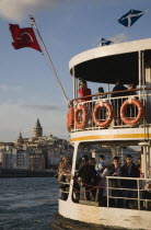 Turkey, Istanbul, Sultanahmet, Crowded passenger ferry flying Turkish flag on the Bosphorous with city behind. Since March 2006, Istanbuls traditional commuter ferries have been operated by Istanbul S...
