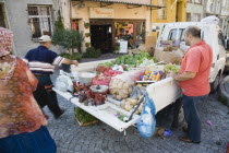 Turkey, Istanbul, Sultanahmet. Fresh fruit and vegetable produce arrives by truck for local shoppers. Set of scales on tail gate with sacks of potatoes and boxes of oranges in the back.