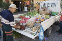 Turkey, Istanbul, Sultanahmet, Fresh produce arrives by truck for local shoppers with set of scales on the open tail gate and back filled with sacks of potatoes, boxes of oranges, apples, grapes and l...