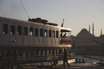 Turkey, Istanbul, Sultanahmet. Bosphorous passenger ferry at sunset with Hagia Sophia behind.