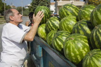 Turkey, Aydin Province, Kusadasi. Unloading fresh, striped green melons delivered to the head chef at Hotel Ladies Beach.