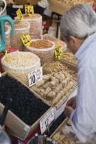 Turkey, Istanbul, Sultanahmet. The Spice Bazaar or Egyptian Bazaar, one of the oldest bazaars in the city and the second largest covered shopping complex after the Grand Bazaar. Shopkeeper prepares di...