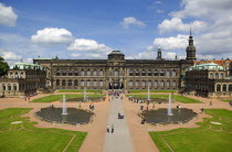 GERMANY, Saxony, Dresden, Tourists in the central courtyard of the restored Baroque Zwinger Palace gardens originally built between 1710 and 1732 after a design by Matthus Daniel Pppelmann in collab...
