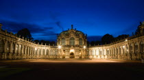 GERMANY, Saxony, Dresden, The Rampart Pavilion illuminated at night topped with a statue of Hercules in the restored Baroque Zwinger Palace gardens originally built between 1710 and 1732 after a desig...