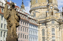 GERMANY, Saxony, Dresden, The restored Baroque church of Frauenkirch and surrounding restored buildings in Neumarkt with a statue in the foreground.