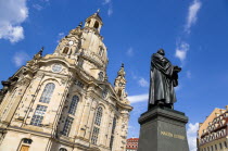 GERMANY, Saxony, Dresden, The restored Baroque church of Frauenkirch and surrounding restored buildings in Neumarkt with a statue of Martin Luther in the foreground.