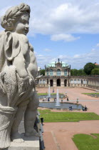 GERMANY, Saxony, Dresden, The central Courtyard and Rampart Pavilion of the restored Baroque Zwinger Palace gardens busy with tourists seen from the statue lined Rampart originally built between 1710...
