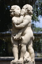 GERMANY, Saxony, Dresden, Statue of two kissing cherubs in the restored Baroque Zwinger Palace Gardens.