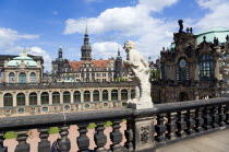 GERMANY, Saxony, Dresden, The central Courtyard of the restored Baroque Zwinger Palace gardens busy with tourists seen from the statue lined Rampart originally built between 1710 and 1732 after a desi...