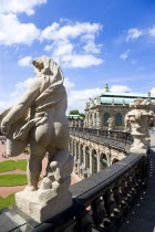 GERMANY, Saxony, Dresden, The central Courtyard of the restored Baroque Zwinger Palace gardens busy with tourists seen from the statue lined Rampart originally built between 1710 and 1732 after a desi...