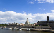 GERMANY, Saxony, Dresden, The city skyline with cruise boats moored on the River Elbe in front of the embankment buildings on the Bruhl Terrace busy with tourists of the Art Academy the Frauenkirche C...