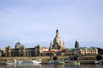 GERMANY, Saxony, Dresden, The city skyline with cruise boats moored on the River Elbe in front of the embankment buildings on the Bruhl Terrace busy with tourists of the Art Academy and the Frauenkirc...