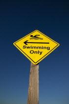 Signs, Warning, Swim area indicating stretch of beach suitable for safe swimming.