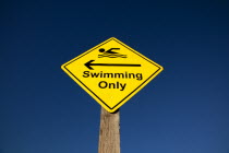 Signs, Warning, Swim area indicating stretch of beach suitable for safe swimming.