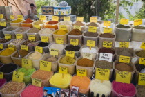 Turkey, Aydin Province, Kusadasi, Stall at weekly market selling spices and tea powders in brightly coloured display.