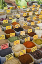 Turkey, Aydin Province, Kusadasi, Satll at weekly market  selling spices and chili powders in brightly coloured display.