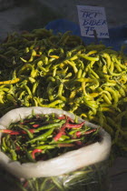 Turkey, Aydin Province, Kusadasi, Red and green chilies for sale on stall at weekly market.