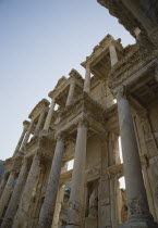 Turkey, Izmir Province, Selcuk, Ephesus, Roman Library of Celsus facade, angled view looking upwards against clear, pale blue sky.