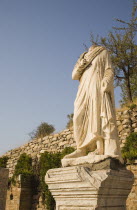 Turkey, Izmir Province, Selcuk, Ephesus, Headless statue on plinth in ancient city of Ephesus on the Aegean sea coast. 