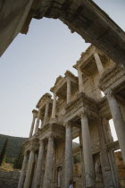 Turkey, Izmir Province, Selcuk, Ephesus, Part view of ornately carved marble facade and archway in antique city of Ephesus on the Aegean sea coast.