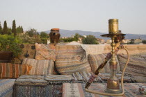 Turkey, Izmir Province, Selcuk, Ephesus, View from rooftop cafe with water pipe on table in foreground and traditional kilim textiles.