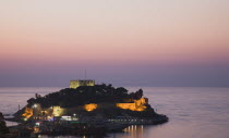 Turkey, Aydin Province, Kusadasi, Sunset over Guvercin Ada, the peninsula of Kusadasi, also known as Pigeon Island.